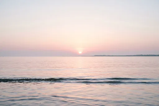 Pastel Sunset Over Calm Coastal Water