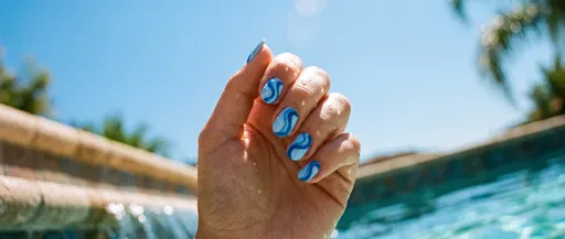 Hand With Blue Swirl Nail Art Poolside