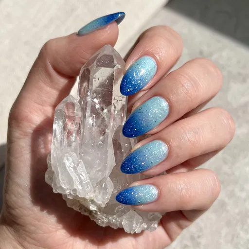 Blue Ombre Glitter Almond Nails Holding Quartz