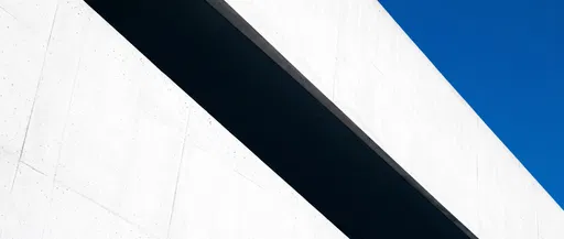 Minimalist White Concrete Architecture Against Blue Sky