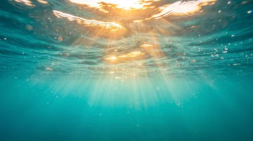 Golden Sunlight Through Turquoise Ocean Surface