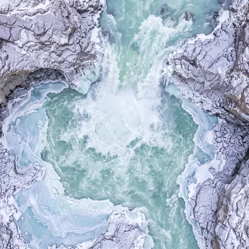 Aerial View of Icy Turquoise Glacial Waterfall