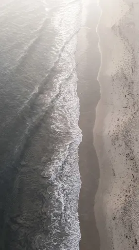 Aerial View of Misty Ocean Shoreline