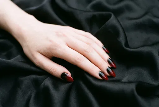 Hand with Black and Red Ombre Nails