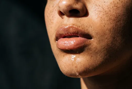 Macro Portrait of Glossy Lips and Skin