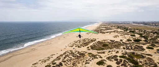 Hang Glider Over Coastal Sand Dunes