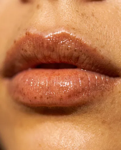 Macro Close-Up of Glossy Freckled Lips