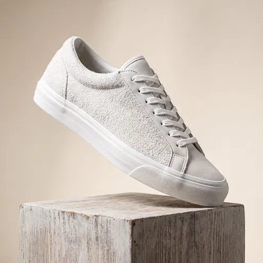 White Suede Sneaker on Wooden Cube