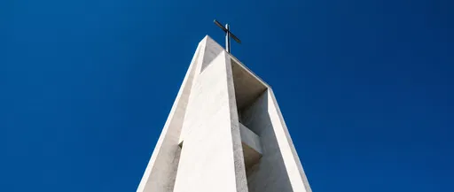 Modern White Church Tower Against Blue Sky