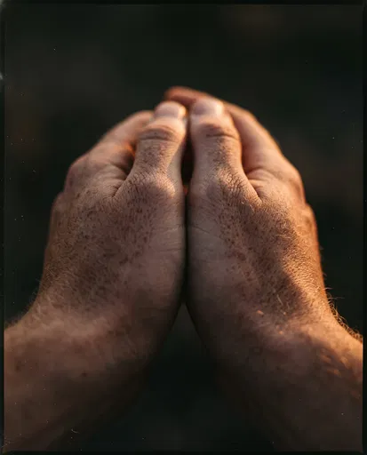 Close-Up of Freckled Hands in Warm Light
