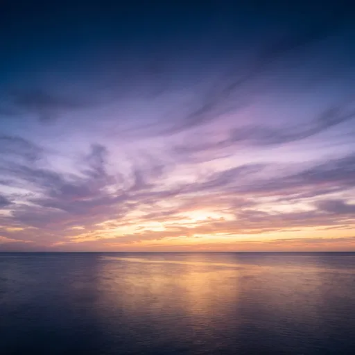 Pastel Dawn Clouds Over Calm Ocean