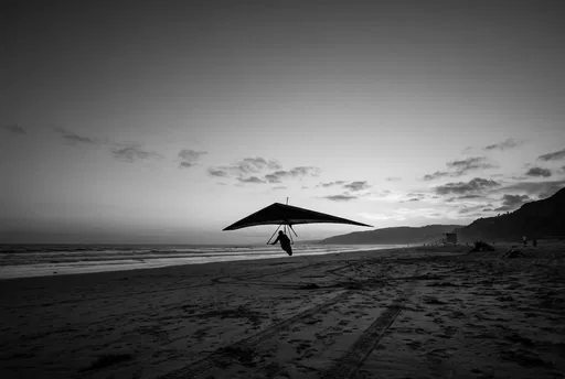 Monochrome Silhouette of Hang Glider Landing