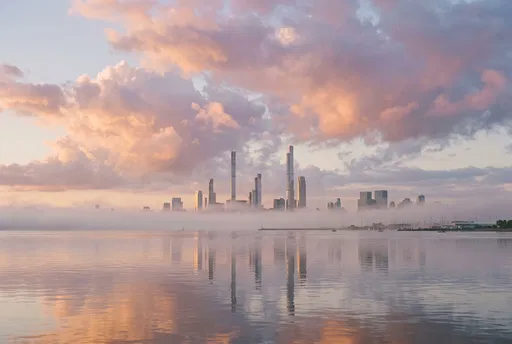 Misty Sunrise Skyline Over Calm Harbor