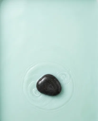 Black Stone in Mint Water Ripples