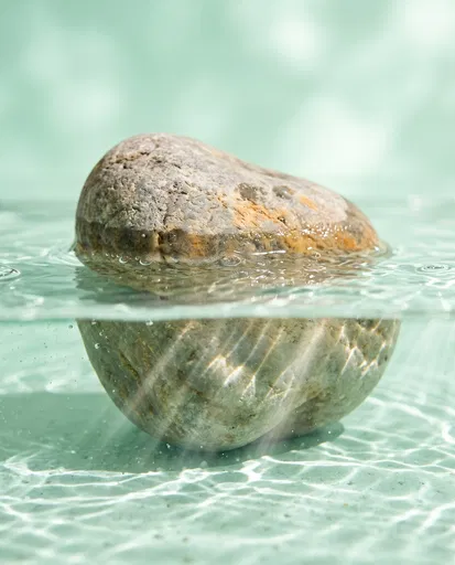 Half-Submerged River Stone in Mint Water