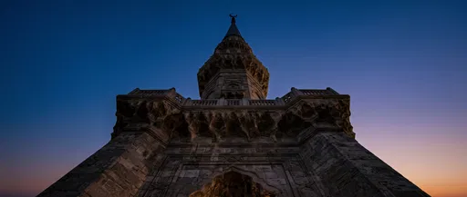 Stone Minaret Against Twilight Sky