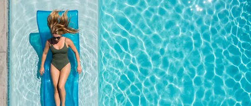 Woman Relaxing on Pool Lounger Overhead
