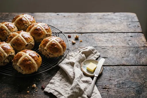 Glazed Hot Cross Buns on Rustic Table