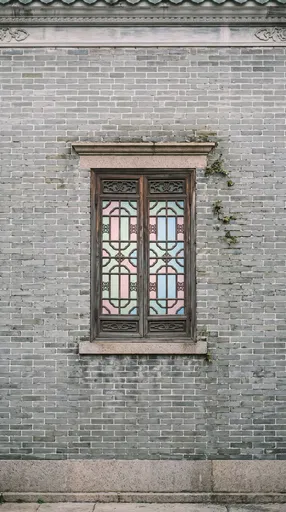 Traditional Chinese Window in Grey Brick Wall