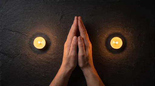 Praying Hands with Two Lit Candles