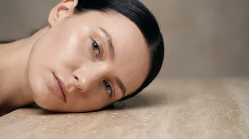 Woman Resting Face on Stone Surface