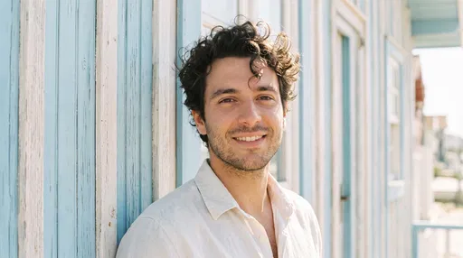 Smiling Man Beside Striped Beach House