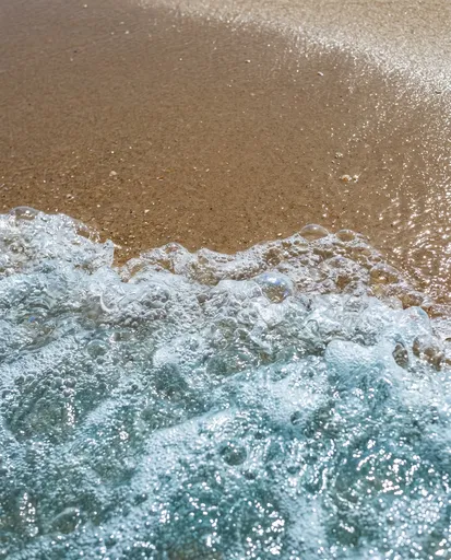 Turquoise Ocean Foam on Wet Sand