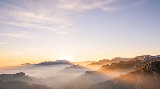 Golden Sunrise Over Misty Mountain Valley