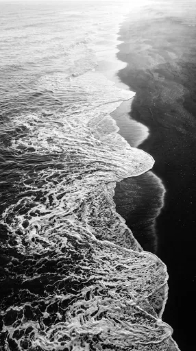 Monochrome Ocean Surf on Black Sand