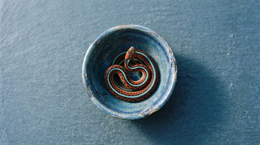 Colorful Garter Snake in Blue Ceramic Bowl