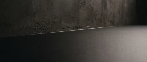 Dark Matte Surface and Textured Plaster Wall