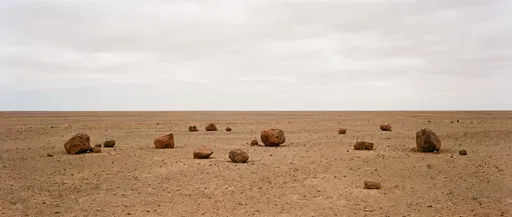 Scattered Boulders on Flat Desert Plain