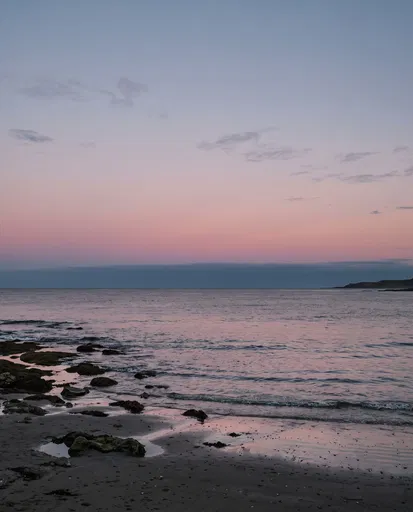 Pastel Twilight Sky Over Calm Rocky Coast