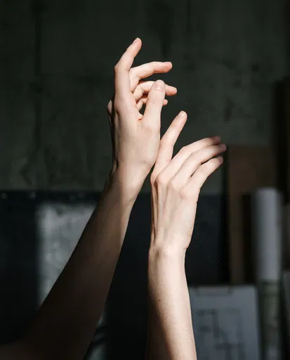 Pale Hands Reaching Into Studio Light