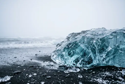 Translucent Blue Ice on Black Sand