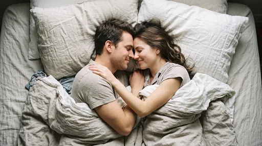 Couple Cuddling in Neutral Linen Bed