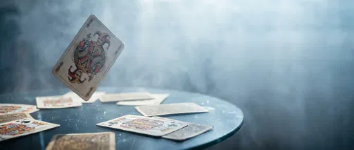 Vintage Joker Card Floating Over Glass Table