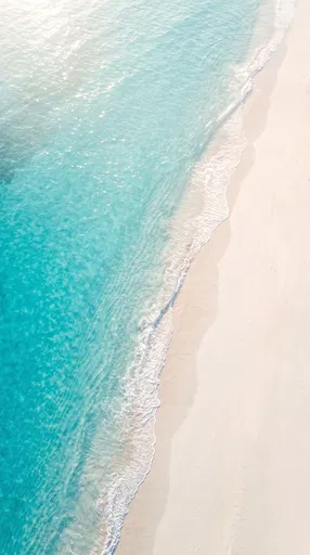 Aerial View of Turquoise Ocean and White Sand