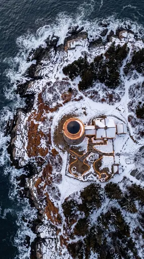 Aerial View of Festive Winter Lighthouse