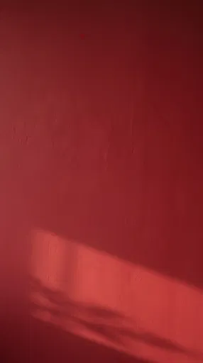 Crimson Wall with Diagonal Sunlight Shadow