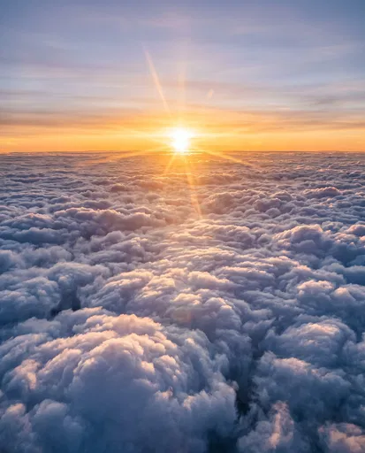 Golden Sunrise Above Sea of Clouds