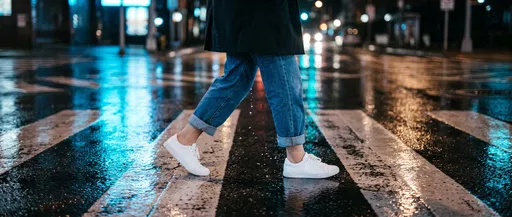 Person Walking Across Wet City Crosswalk