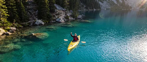 Kayaker Giving Thumbs Up on Alpine Lake