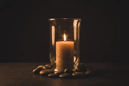 Lit Pillar Candle in Glass Hurricane Lantern