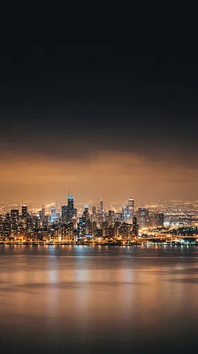 Illuminated City Skyline Across Night Harbor