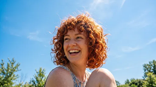 Joyful Woman With Curly Red Hair Outdoors
