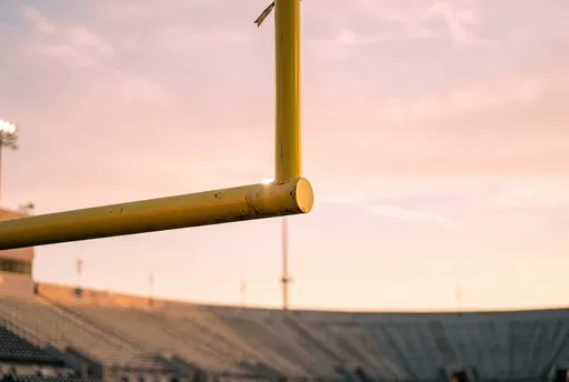 Yellow Football Goalpost at Sunset