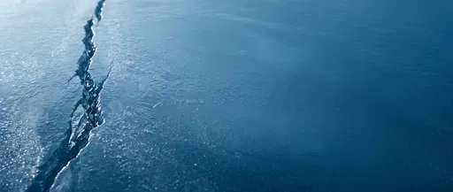 Cracked Blue Ice Background with Copy Space