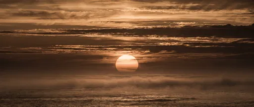 Sepia Sunset Over Misty Ocean Horizon