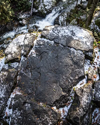 Snow Dusted Basalt Rock by Forest Stream